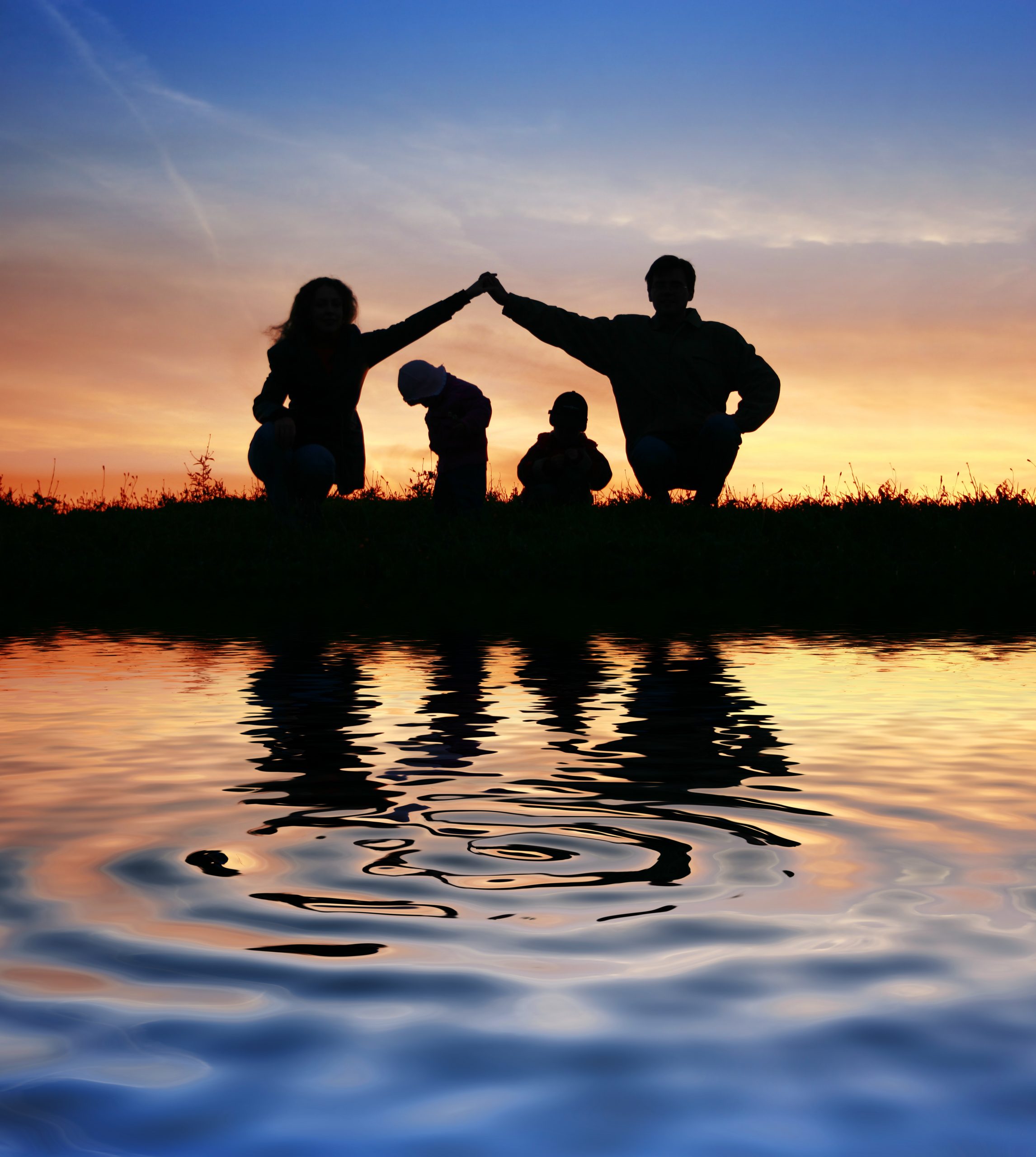 A family together in a park after being helped by a Rochester NY adoption lawyer